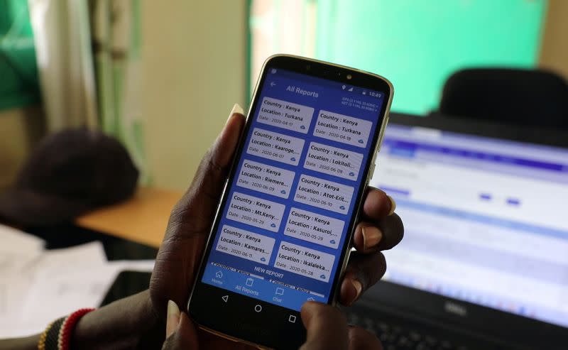 Turkana sub county crops officer Alfons Aurun displays the E-locust phone app at his office in the town of Lodwar, Turkana county