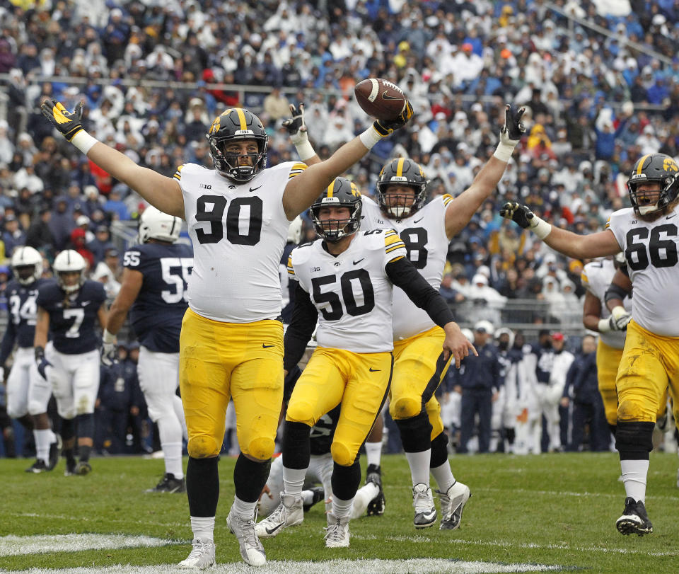 Iowa's Sam Brincks (90) celebrates after catching a touchdown pass against Penn State during the first half of an NCAA college football game in State College, Pa., Saturday, Oct. 27, 2018. (AP Photo/Chris Knight)