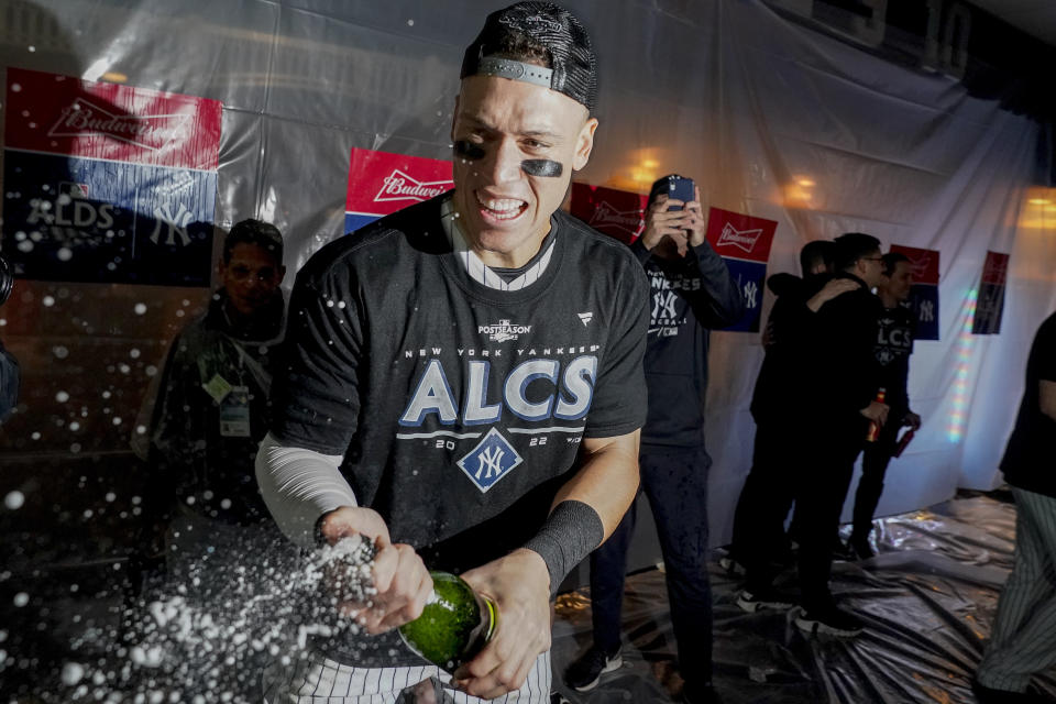 New York Yankees center fielder Aaron Judge celebrates in the locker room after the Yankees defeated the Cleveland Guardians in Game 5 of an American League Division baseball series, Tuesday, Oct. 18, 2022, in New York. (AP Photo/John Minchillo)