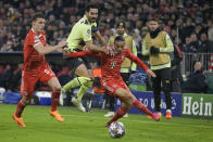 Manchester City's Ilkay Gundogan, center, duels for the ball with Bayern's Leroy Sane, right, and Bayern's Benjamin Pavard during the Champions League quarter finals second leg soccer match between Bayern Munich and Manchester City, at the Allianz Arena stadium in Munich, Germany, Wednesday, April 19, 2023. (AP Photo/Andreas Schaad)