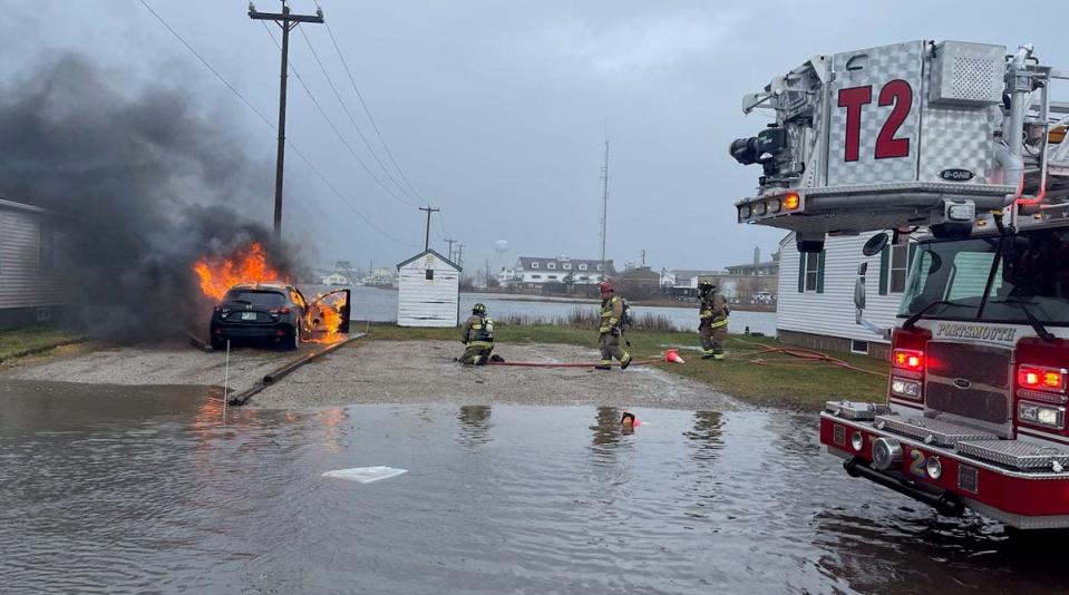 Portsmouth firefighters respond to a car fire at 48 Hobson Ave. at Hampton Beach during a storm surge Friday, Dec. 23, 2022.