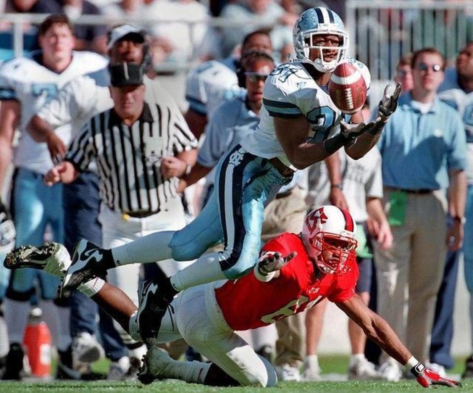 North Carolina’s Dre Bly intercepts a pass intended for N.C. State’s Tory Holt during their game in 1998 at what is now Bank of America Stadium in Charlotte. The Tar Heels won 37-34 in overtime.