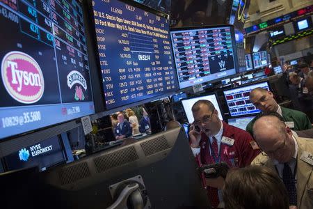 Traders gather at the post that trades Tyson Foods on the floor of the New York Stock Exchange in this June 3, 2014 file photo. REUTERS/Brendan McDermid/Files