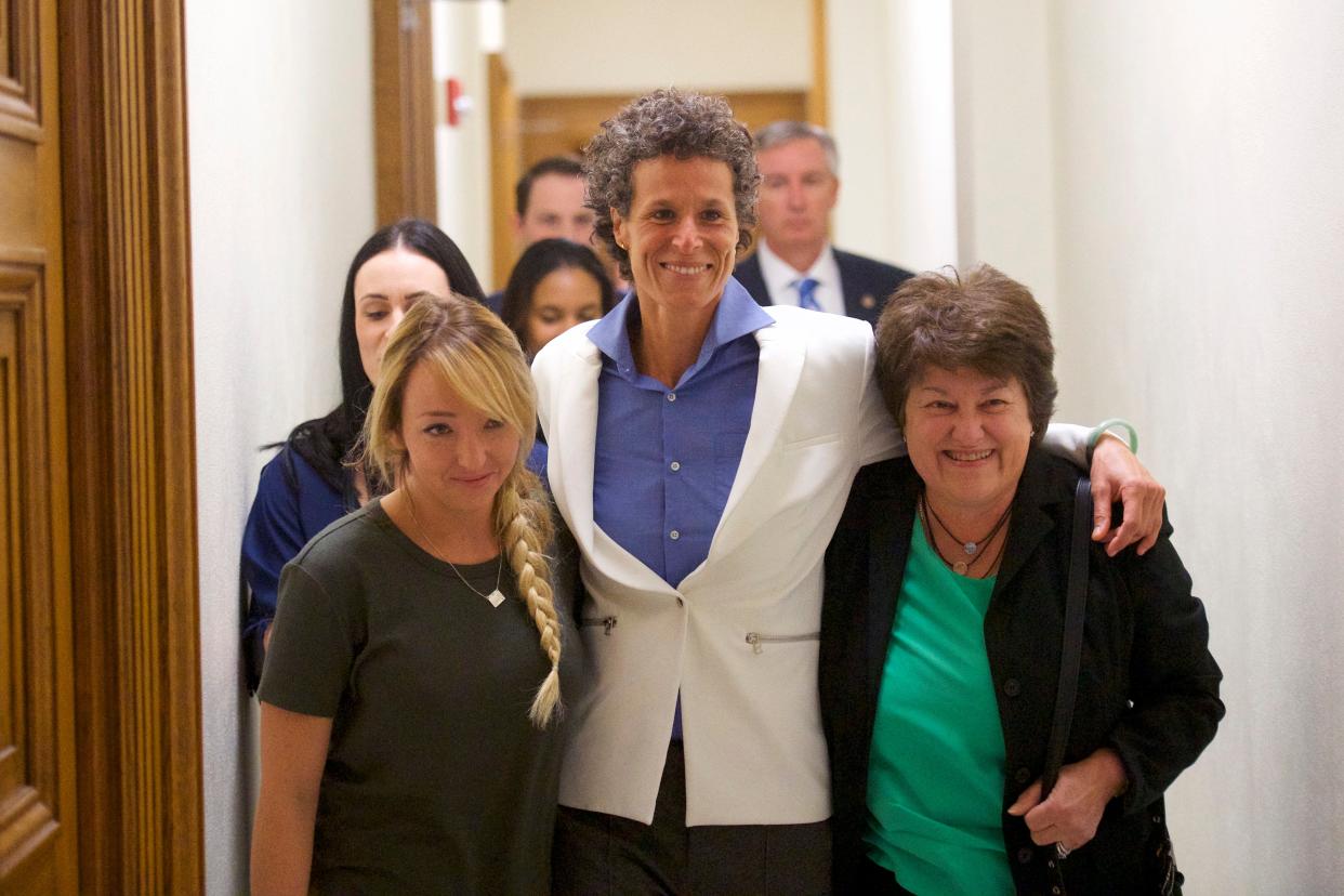 Bill Cosby accuser Andrea Constand (C) reacts with lawyer Dolores Troiani (R) and Delaney Henderson (L) after the guilty on all counts verdict was delivered in the sexual assault retrial at the Montgomery County Courthouse on April 26, 2018 in Norristown, Pennsylvania (Getty Images)