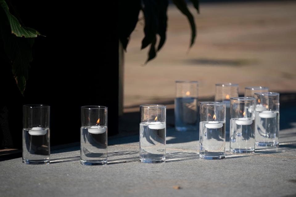 Candles rest in front of the podium before the start of the Nashville Remembers candlelight vigil to honor the victims of The Covenant School mass shooting at Public Square Park Wednesday, March 29, 2023 in Nashville, Tenn. 