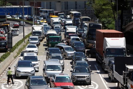 Traffic is seen after protesters placed barricades to block the road, at the Cross-Harbour Tunnel in Hong Kong