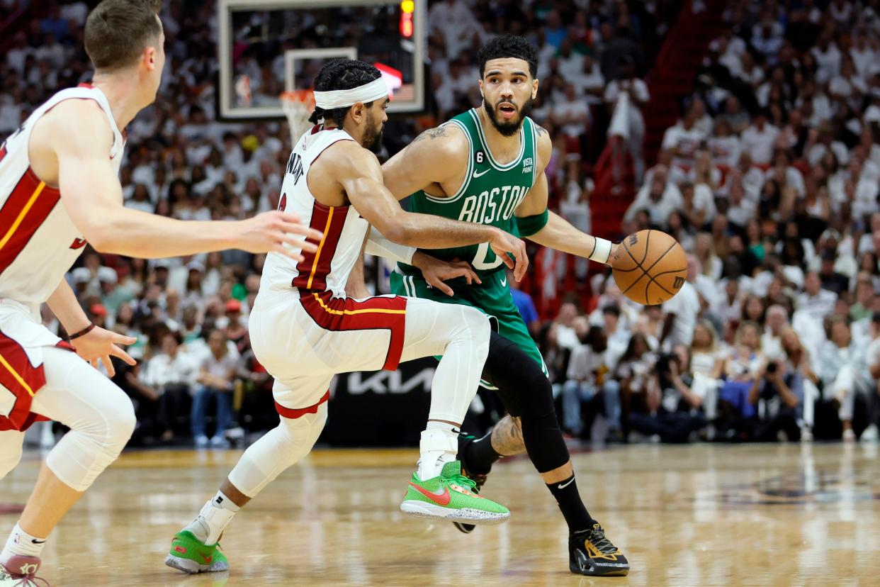 The Boston Celtics' Jayson Tatum controls the ball against the Miami Heat's Gabe Vincent during Game 6.