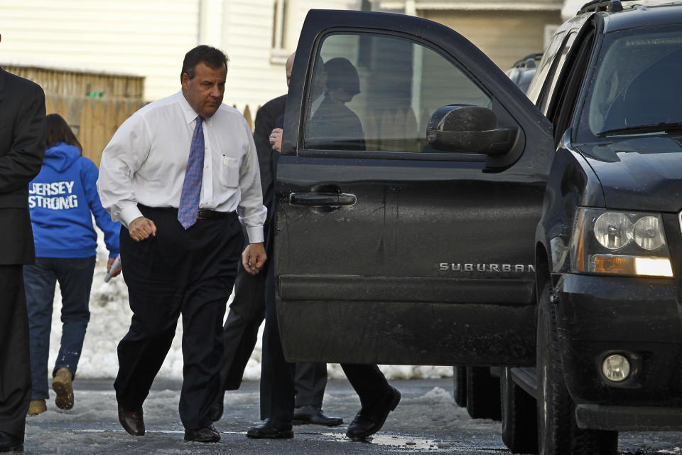 KEANSBURG, NJ - FEBRUARY 04: New Jersey Gov. Chris Christie (L) walks to his car after a press conference with families affected by Superstorm Sandy at a lounge in the New Point Comfort Fire Company on February 4, 2014 in Keansburg, New Jersey. Christie, whose governorship is being threatened by a scandal is facing federal investigation over use of Sandy funds. (Photo by Kena Betancur/Getty Images)