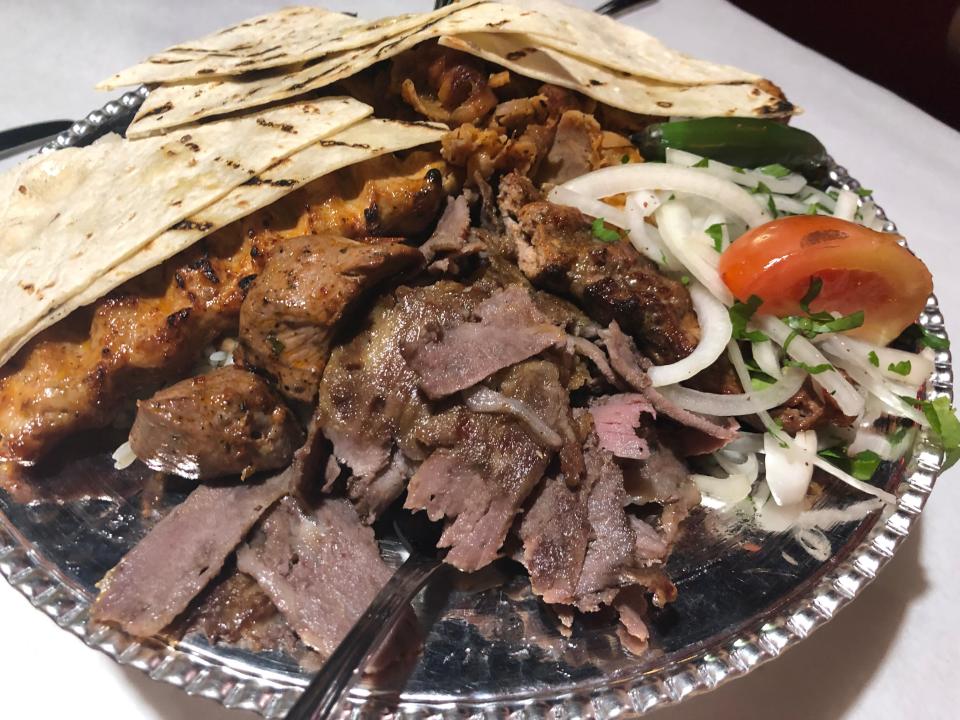 The mixed grill platter ($39.95) from Vourla Mediterranean Grill and Cafe in Naples is comprised of Lamb and beef Doner Kebab, Chicken Doner Kebab, Chicken Adana Kebab, Chicken Sis Kebab, Lamb Sis Kebab and Adana Kebab paired with onions, tomato and pita slices.