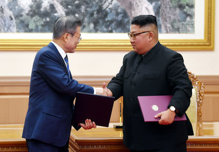 South Korean President Moon Jae-in shakes hands with North Korean leader Kim Jong Un after signing the joint statement in Pyongyang, North Korea, September 19, 2018. Pyeongyang Press Corps/Pool via REUTERS