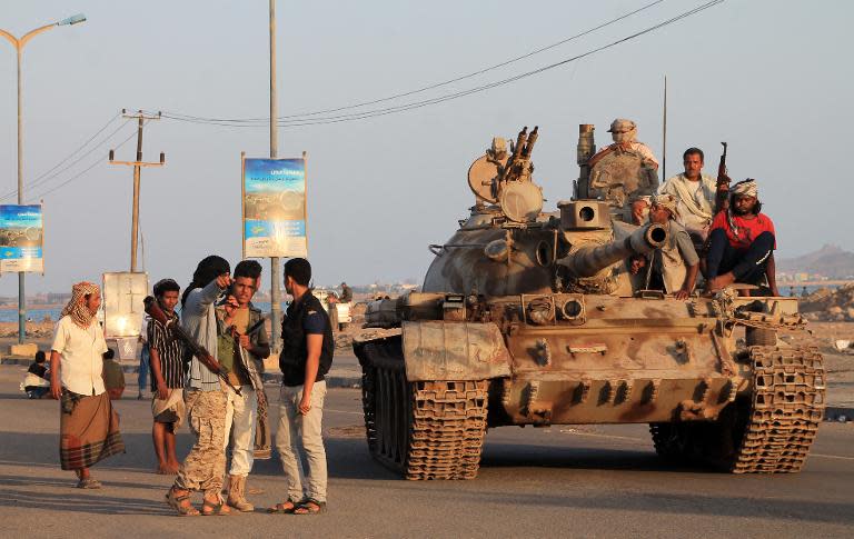 Yemeni members of the southern separatist movement, loyal to President Abedrabbo Mansour Hadi, sit atop a tank on April 19, 2015 in Aden