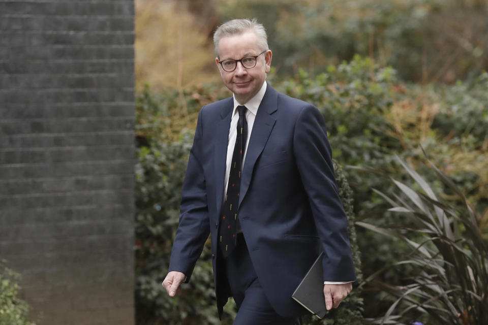 FILE - In this file photo dated Thursday, Feb. 13, 2020, British lawmaker Michael Gove arrives at 10 Downing Street in London.  The British government is expected to water down plans for full border checks on goods coming from the European Union amid economic devastation caused by the coronavirus pandemic, according to new reports Friday June 12, 2020, Michael Gove, the minister in charge of Brexit preparations, will announce a more “pragmatic and flexible” approach to imports.  (AP Photo/Matt Dunham, FILE)