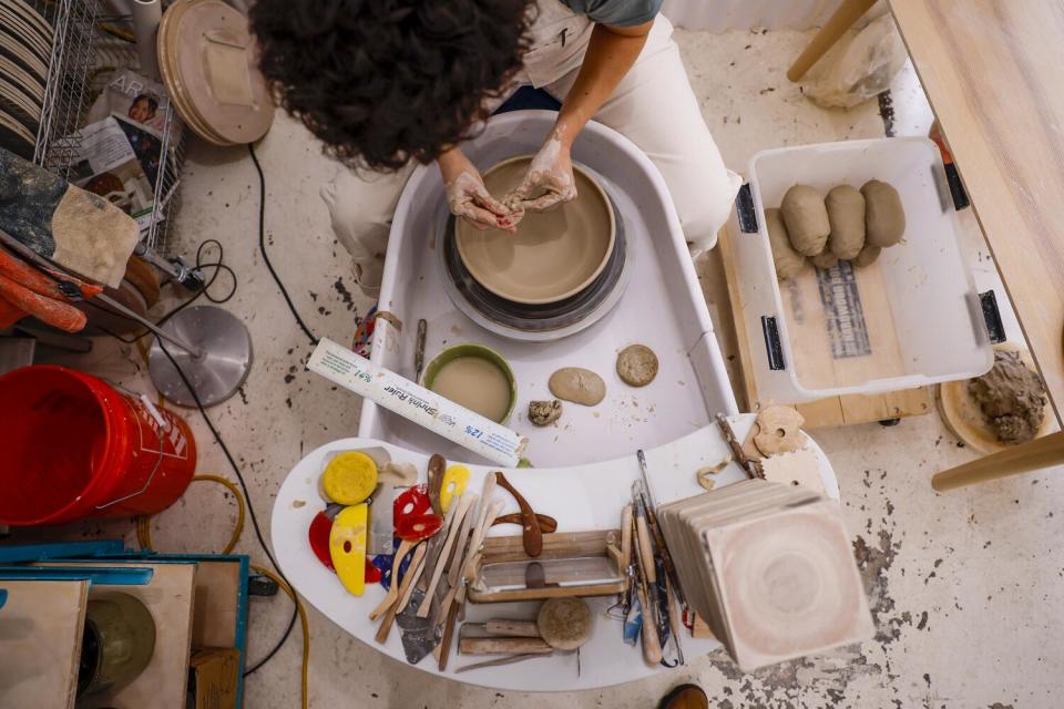 Potter Becki Chernoff crafts a bowl on the wheel.