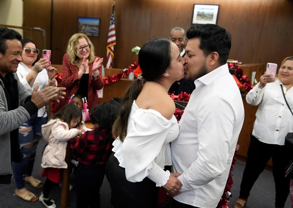 Surrounded by family members, Alejandra Ortiz and Francisco Pineda are married by Judge Mike McAllister in Franklin County Municipal Court on Valentine's Day.