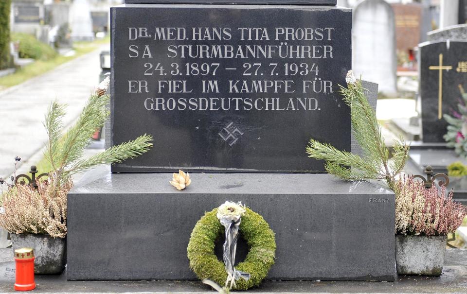 This picture taken Tuesday, Jan. 21, 2014 shows a marble tombstone which is adorned by a swastika and the inscription “He died in the struggle for a Great Germany” at the central cemetery in Graz, Austria. Austrian law bans such symbols, and those displaying them face criminal charges and potential prison terms. Yet the emblems reflecting this country’s darkest chapter in history endure here, and officials here appear either unable or unwilling to do away with them. (AP Photo/Hans Punz)