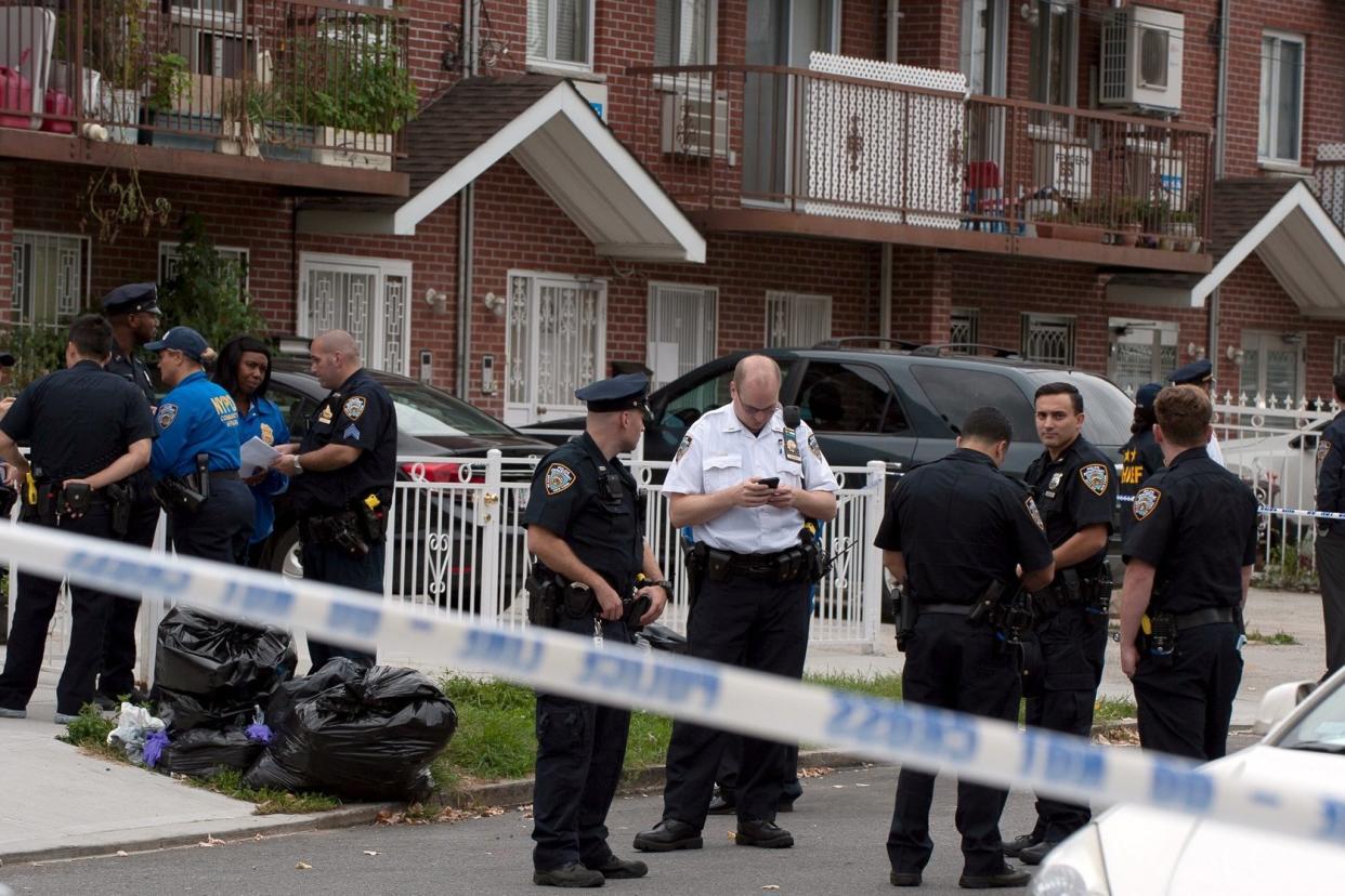 Police at the scene of the stabbings at the daycare centre in Queens: REUTERS