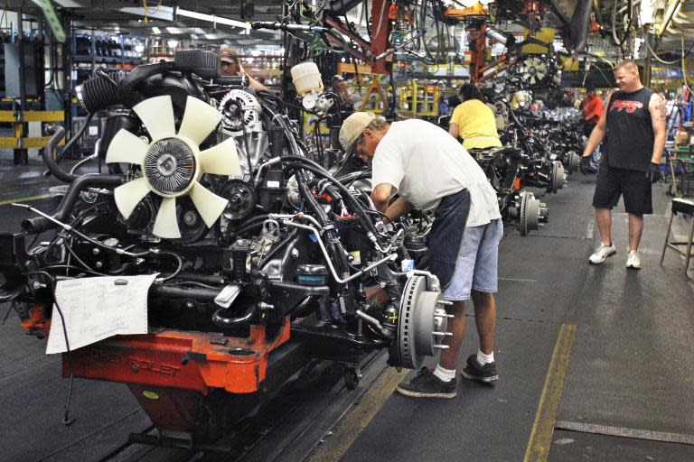 Workers assemble trucks on the General Motors assembly line in Flint, Michigan