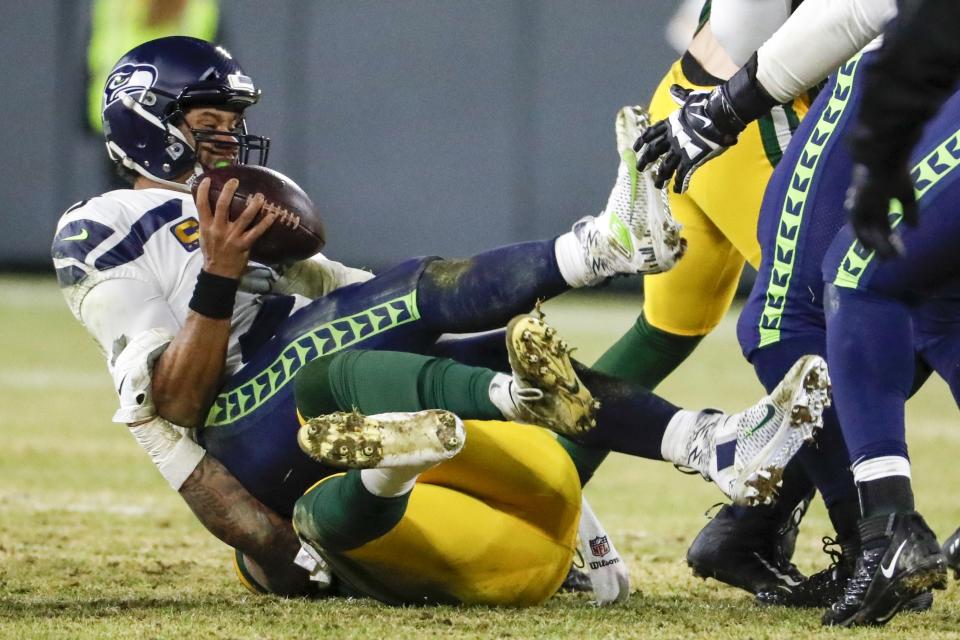 Green Bay Packers' Preston Smith sacks Seattle Seahawks' Russell Wilson during the second half of an NFL divisional playoff football game Sunday, Jan. 12, 2020, in Green Bay, Wis. (AP Photo/Matt Ludtke)