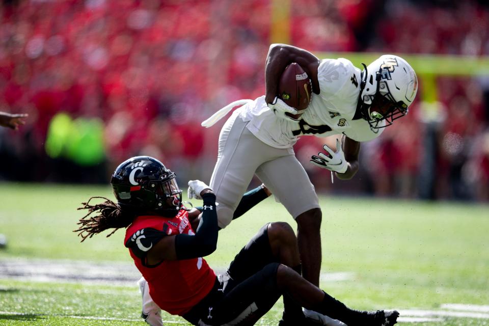 Cincinnati Bearcats cornerback Arquon Bush (9) tackles UCF Knights wide receiver Ryan O'Keefe (4) in the first half of their game last season at Nippert Stadium. O'Keefe finished with 60 yards on seven catches, including one for a 33-yard gain. O'Keefe also had a 51-yard carry in the loss.
