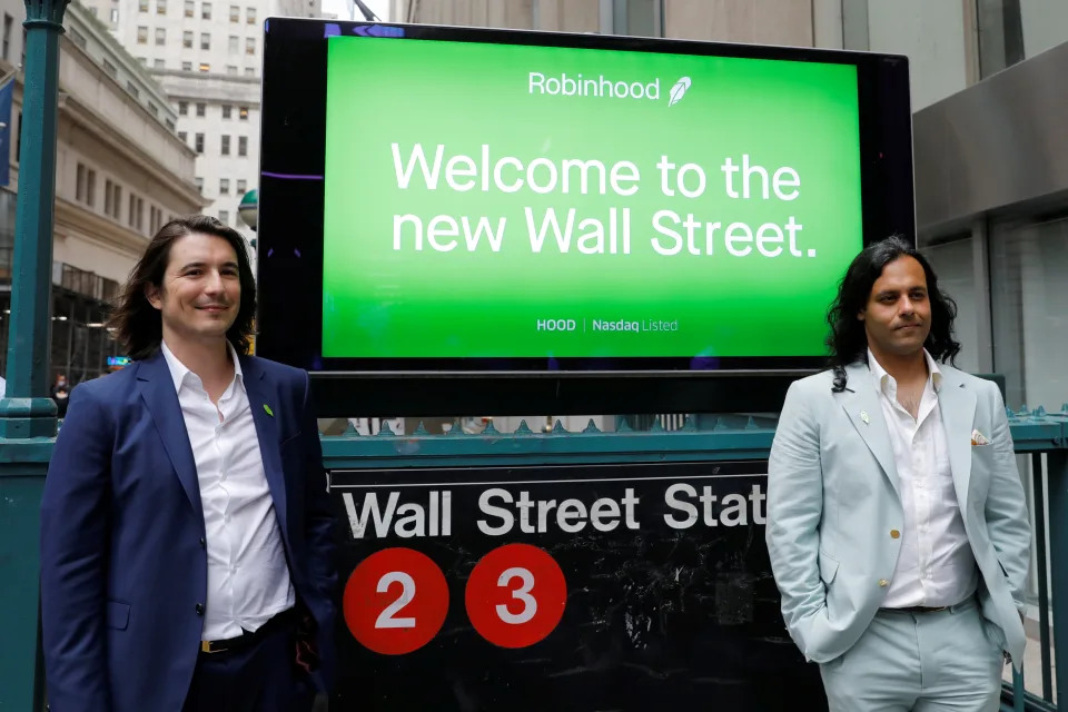 Robinhood Markets, Inc. CEO and co-founder Vlad Tenev and co-founder Baiju Bhatt pose with Robinhood signage on Wall Street after the company's IPO in New York City, U.S., July 29, 2021.  REUTERS/Andrew Kelly