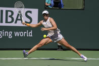 Iga Swiatek, of Poland, returns to Sorana Cirstea, of Romania, at the BNP Paribas Open tennis tournament Thursday, March 16, 2023, in Indian Wells, Calif. (AP Photo/Mark J. Terrill)