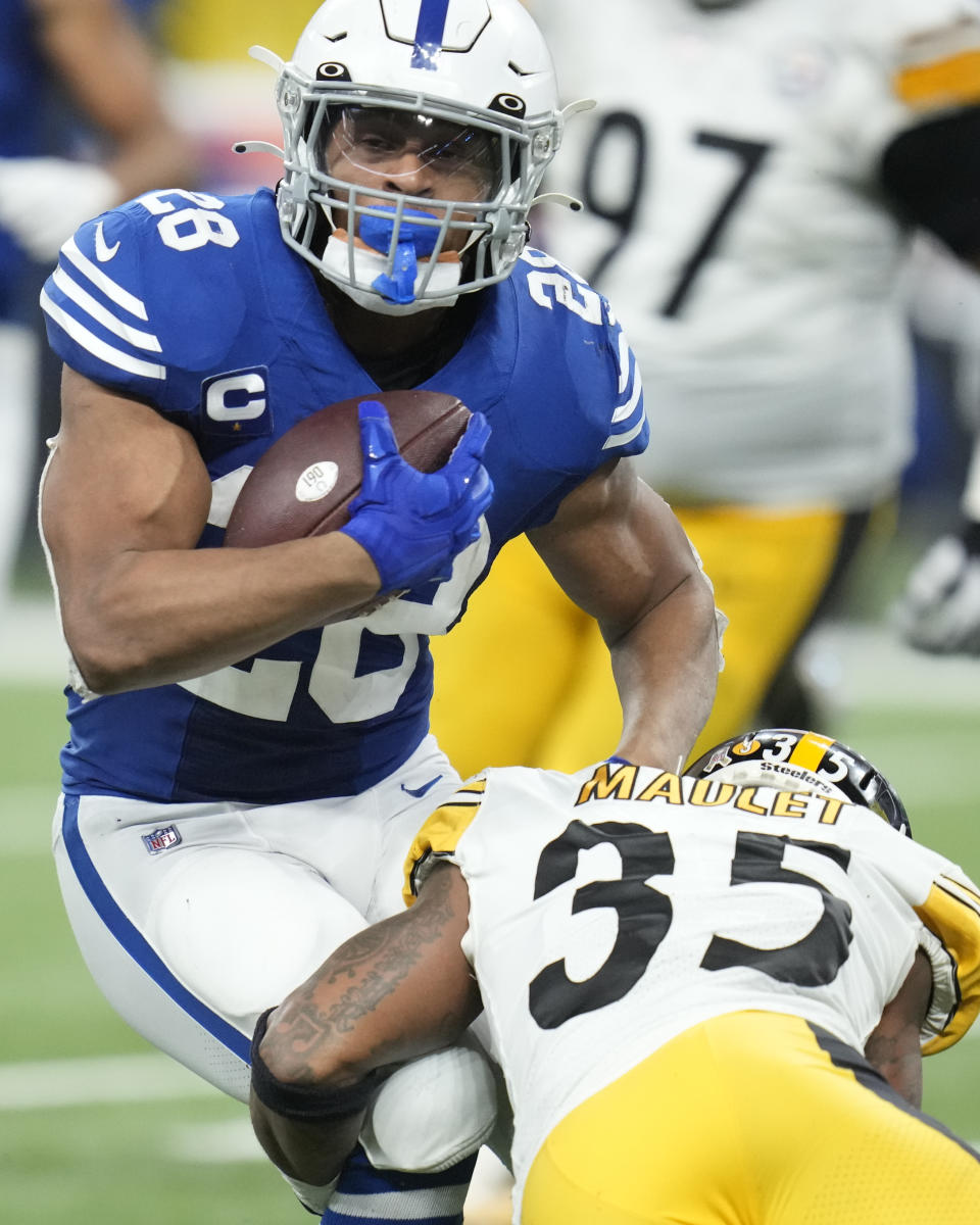 Indianapolis Colts' Jonathan Taylor (28) is tackled by Pittsburgh Steelers' Arthur Maulet (35) during the second half of an NFL football game, Monday, Nov. 28, 2022, in Indianapolis. (AP Photo/Michael Conroy)