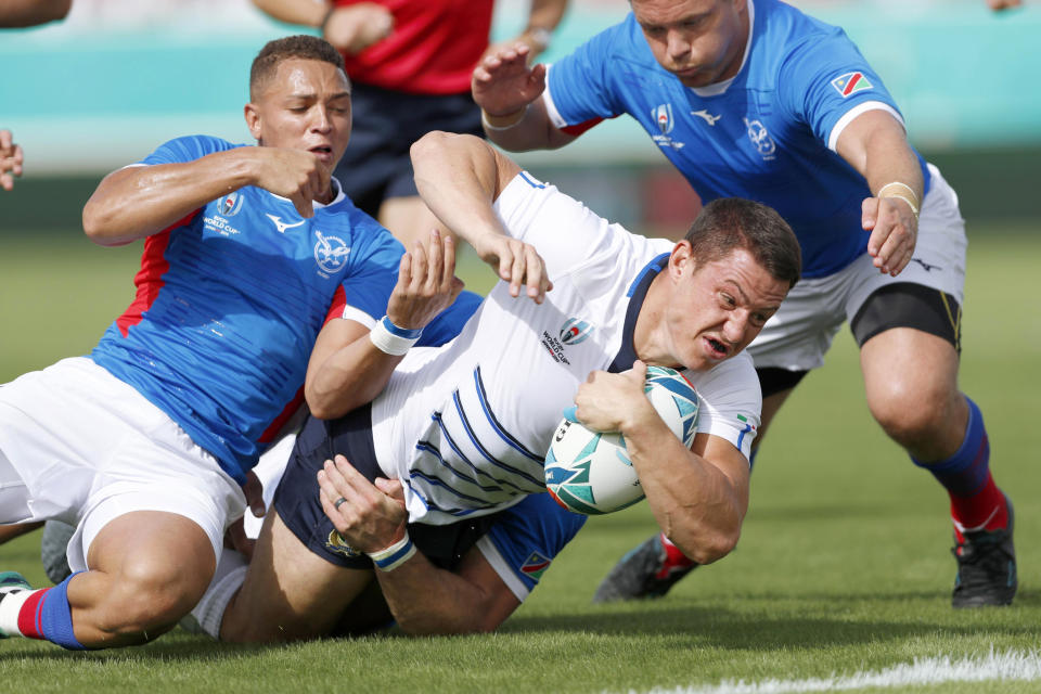 Italy’s Luca Morisi, center, is tackled by Namibia during the Rugby World Cup Pool B game between Italy and Namibia in Osaka, western Japan, Sunday, Sept. 22, 2019. (Ichiro Sakano/Kyodo News via AP)