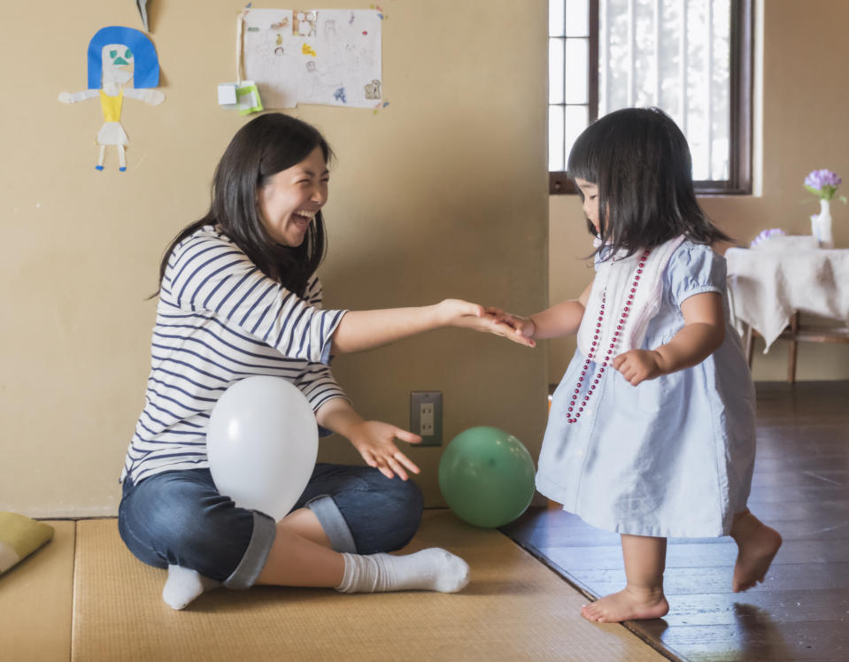 A woman high fives her niece at a birthday celebration