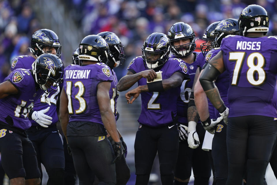 Baltimore Ravens players listen to Baltimore Ravens quarterback Tyler Huntley (2) in the second half of an NFL football game against the Denver Broncos, Sunday, Dec. 4, 2022, in Baltimore. (AP Photo/Patrick Semansky)