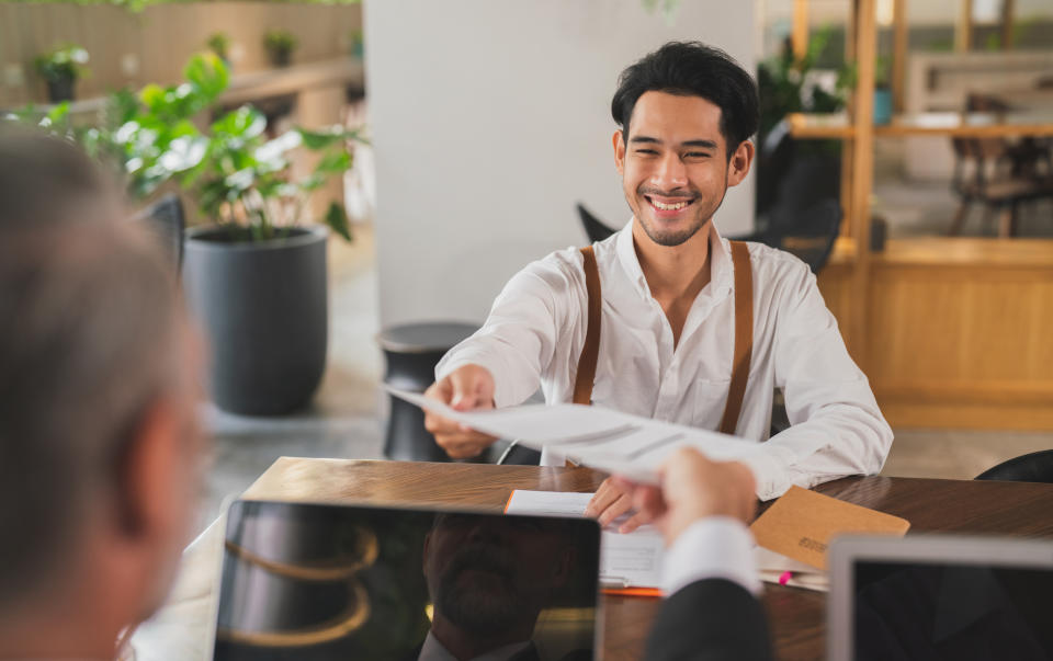 person handing over their resume