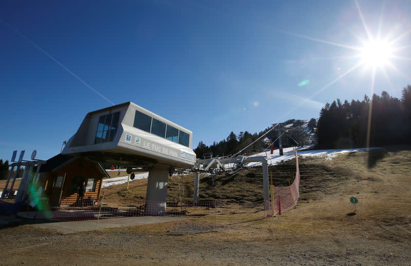 Chairlifts are pictured at the ski resort of The Mourtis, as the ski slopes are closed due to lack of snow in Boutx