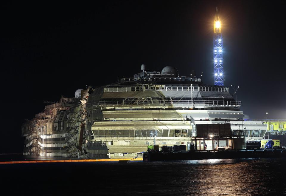 The capsized cruise liner Costa Concordia is seen at the end of the "parbuckling" operation outside Giglio harbour September 17, 2013. Salvage crews completed raising the wreck of the Costa Concordia in the early hours of Tuesday morning after a 19-hour-long operation on the Italian island of Giglio where the huge cruise liner capsized in January last year. REUTERS/Tony Gentile (ITALY - Tags: DISASTER MARITIME TPX IMAGES OF THE DAY)