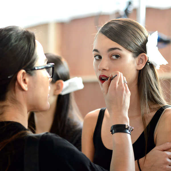 A model gets her make up applied backstage at Antonio Beradi © Getty