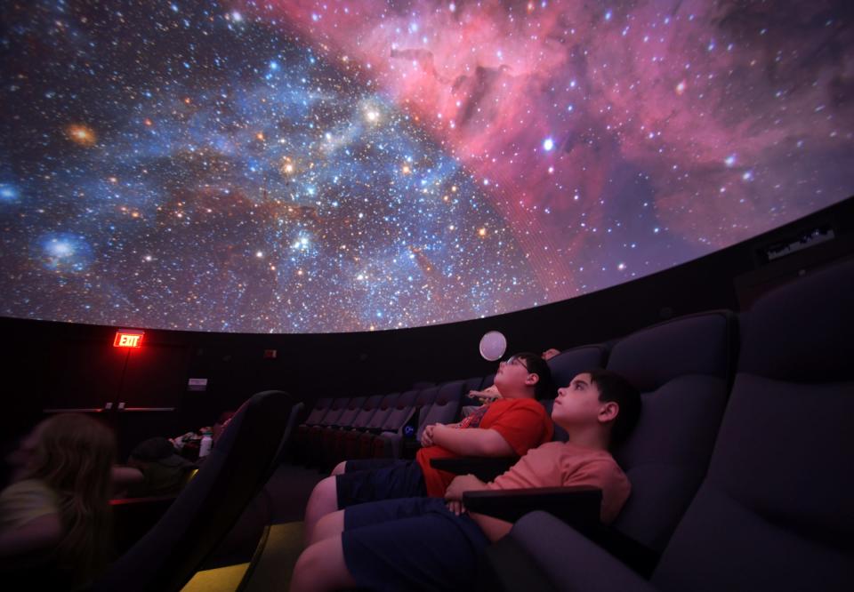 Children watch a show inside the Planetarium at the EcoTarium in Worcester.