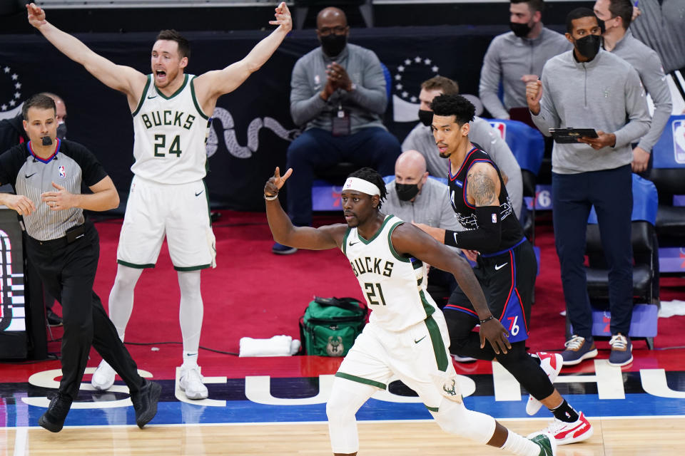 Milwaukee Bucks' Jrue Holiday (21) reacts after making a basket during the second half of an NBA basketball game against the Philadelphia 76ers, Wednesday, March 17, 2021, in Philadelphia. (AP Photo/Matt Slocum)