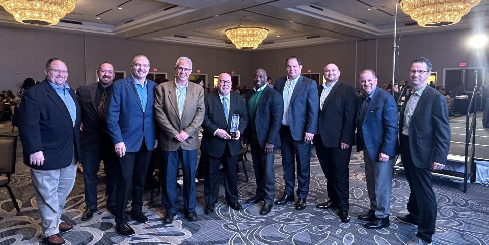Chris Shovlin stands with a number of former and current Robert Morris colleagues at the Pa. Association of Broadcasters Hall of Fame Luncheon in Harrisburg, PA on April 26, 2024.