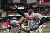 Atlanta Braves' Freddie Freeman celebrates his home run with Joc Pederson during the seventh inning in Game 6 of baseball's World Series between the Houston Astros and the Atlanta Braves Tuesday, Nov. 2, 2021, in Houston.(AP Photo/Eric Gay)