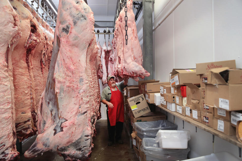 ELMA, IA - JULY 25:  Roger Meirick looks over beef and hogs sides hanging in his cooler awaiting processing at Elma Locker & Grocery on July 25, 2018 in Elma, Iowa. The locker custom butchers hogs and cattle and other livestock for area customers. According to the Iowa Pork Producers Association, Iowa is the number one pork producing state in the U.S. and the top state for pork exports. The state sends about 50 million hogs to market each year and its pork exports totaled more than $1.1 billion in 2017.  Pork producers in Iowa are bracing for the impact a trade war with China and Mexico may have on their bottom line going forward.  (Photo by Scott Olson/Getty Images)