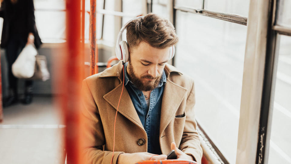 Handsome guy listening to the music on public transport.