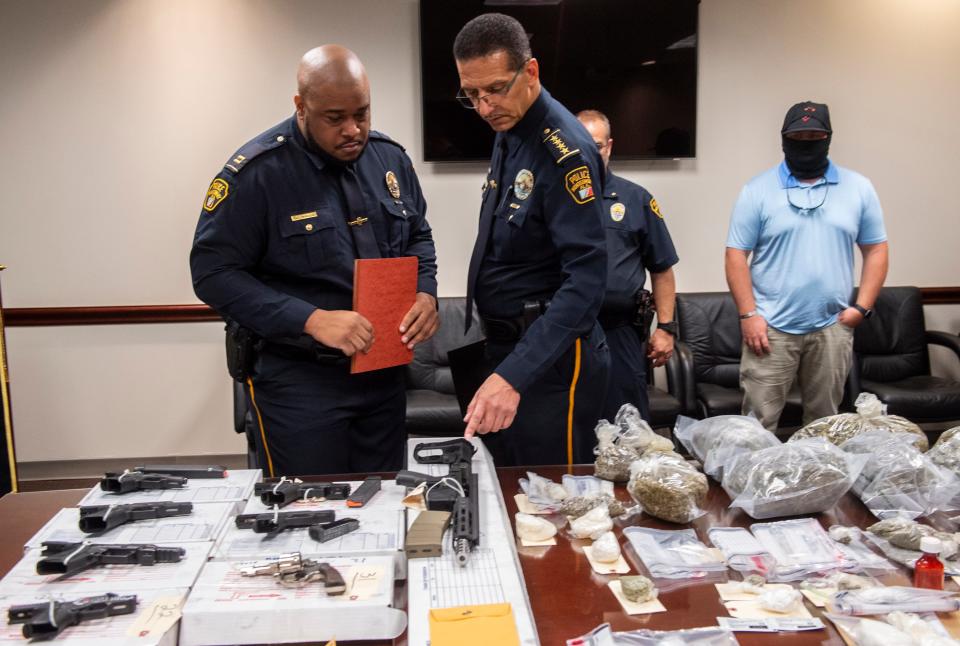 Montgomery Police Capt. Ronald Dorsey and Police Chief Darryl Alberts look over evidence after a press conference at the Montgomery Police Department’s Criminal Investigations office in Montgomery, Alabama, on Aug. 8, 2022.