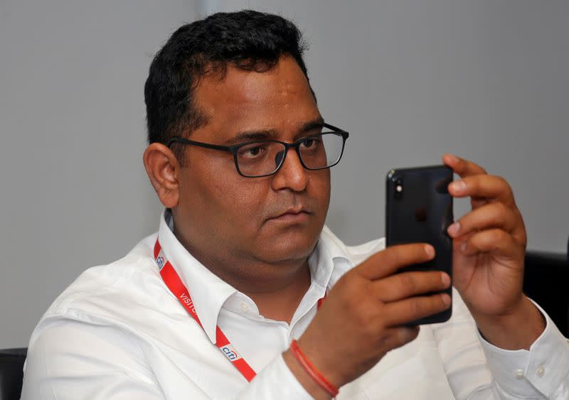 FILE PHOTO: Vijay Shekhar Sharma, founder of Paytm's parent One97 Communications, checks his mobile phone before the launch of a Citibank and Paytm credit card in Mumbai