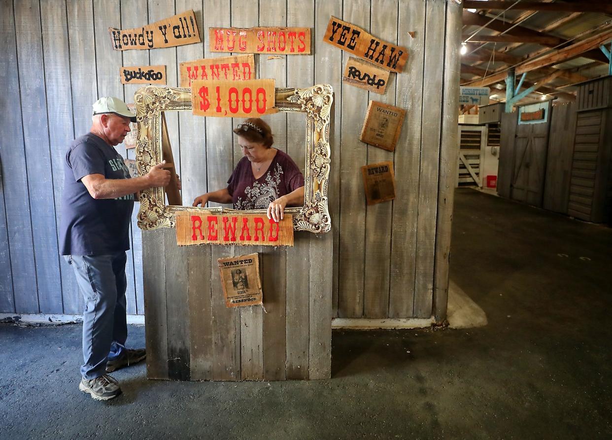 Chuck Edwards, left, and Pat Gascoyne move a standup frame for people to take photos with into position as they get the Miniature Horse barn ready or the Kitsap County Fair and Stampede on Monday. The fair opens on Wednesday morning and runs through Sunday at the Kitsap County Fairgrounds.