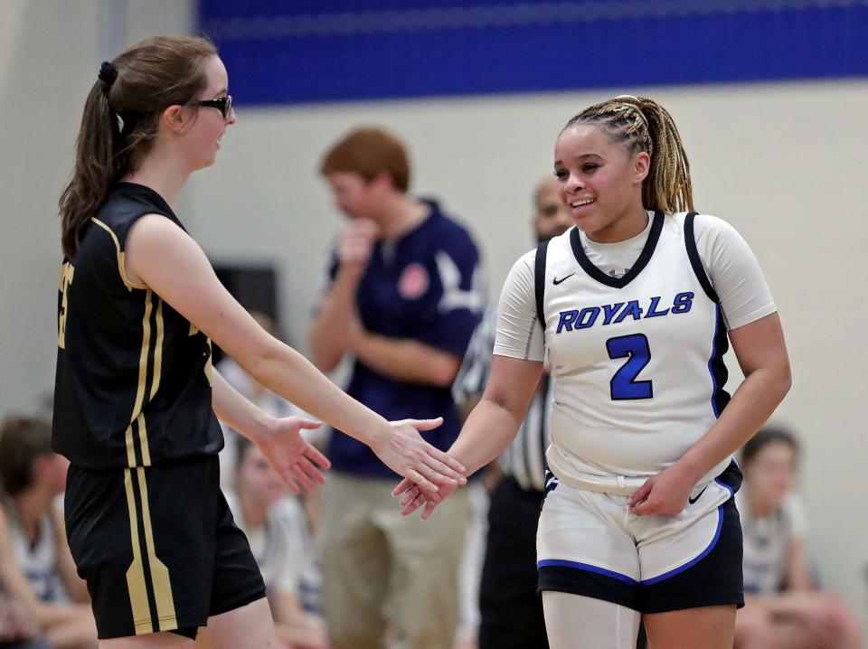 CVCA junior Joi Williams, right, is congratulated by Hathaway Brown’s Emily Morgan after scoring her 1,000th career point during the first half of a high school basketball game, Wednesday, Jan. 24, 2024, in Cuyahoga Falls, Ohio.