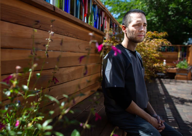 RENO, NV - SEPTEMBER 08: Alex Cabrera, medical student at the University of Nevada, Reno, a former Bernie Sanders supporter, who will now be voting for Joe Biden, poses for a portrait at a local coffee shop on Tuesday, Sept. 8, 2020 in Reno, NV (Jason Armond / Los Angeles Times)