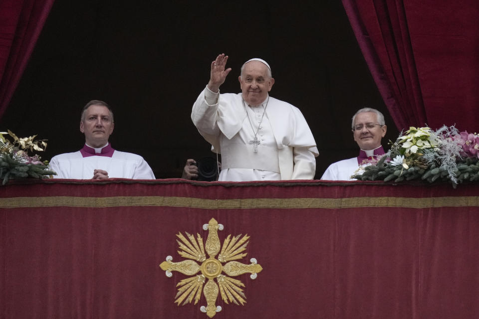 Pope Francis waves on the occasion of the Urbi et Orbi (Latin for 'to the city and to the world' ) Christmas' day blessing from the main balcony of St. Peter's Basilica at the Vatican, Monday Dec. 25, 2023. (AP Photo/Gregorio Borgia)