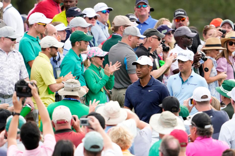 Apr 4, 2022; Augusta, Georgia, USA; Tiger Woods and Justin Thomas walk through a crush of patrons to get to the no. 8 tee box during a practice round of The Masters golf tournament at Augusta National Golf Club. Mandatory Credit: Rob Schumacher-USA TODAY Sports