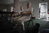 Jane Compton, right, and her husband, Del Compton, center, sit with other parishioners at the Southwest Baptist Church in Fort Myers, Fla., Sunday, Oct. 2, 2022. The Comptons are among nearly a dozen church members who are living at the church after their homes were destroyed by Hurricane Ian. (AP Photo/Robert Bumsted)