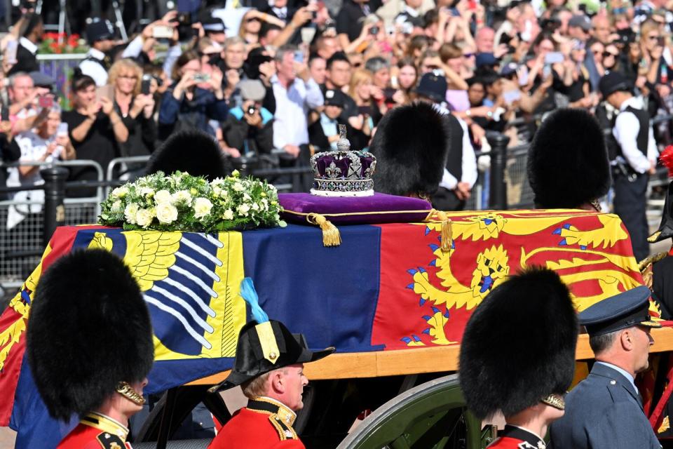 The coffin carrying Queen Elizabeth II makes its way along The Mall during the procession for the Lying-in State of Queen Elizabeth II on September 14, 2022 in London, England