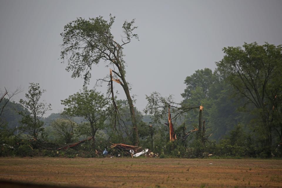 Twisted trees and debris were spread in fields south of Oak Harbor near Ohio 19.