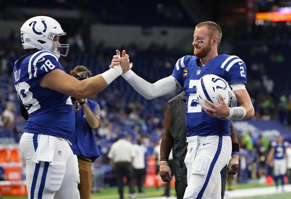 Indianapolis Colts center Ryan Kelly (78) and Indianapolis Colts quarterback Carson Wentz (2) meet on the field during warmups Sunday, Sept. 12, 2021, before the regular season opener against the Seattle Seahawks at Lucas Oil Stadium in Indianapolis.